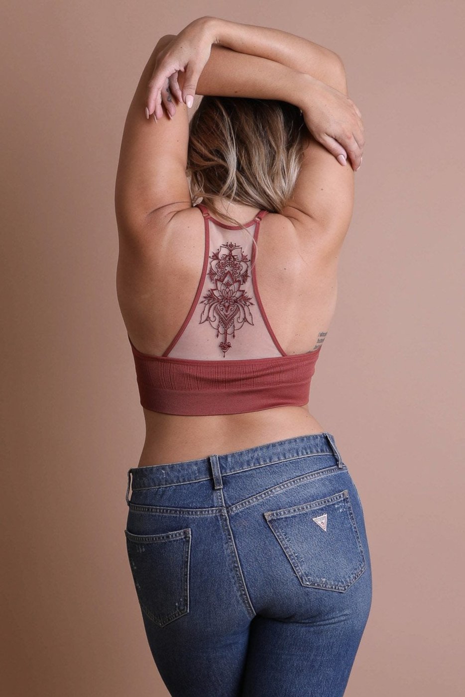 Feminine tattoo back rust bralette with mesh racerback style.