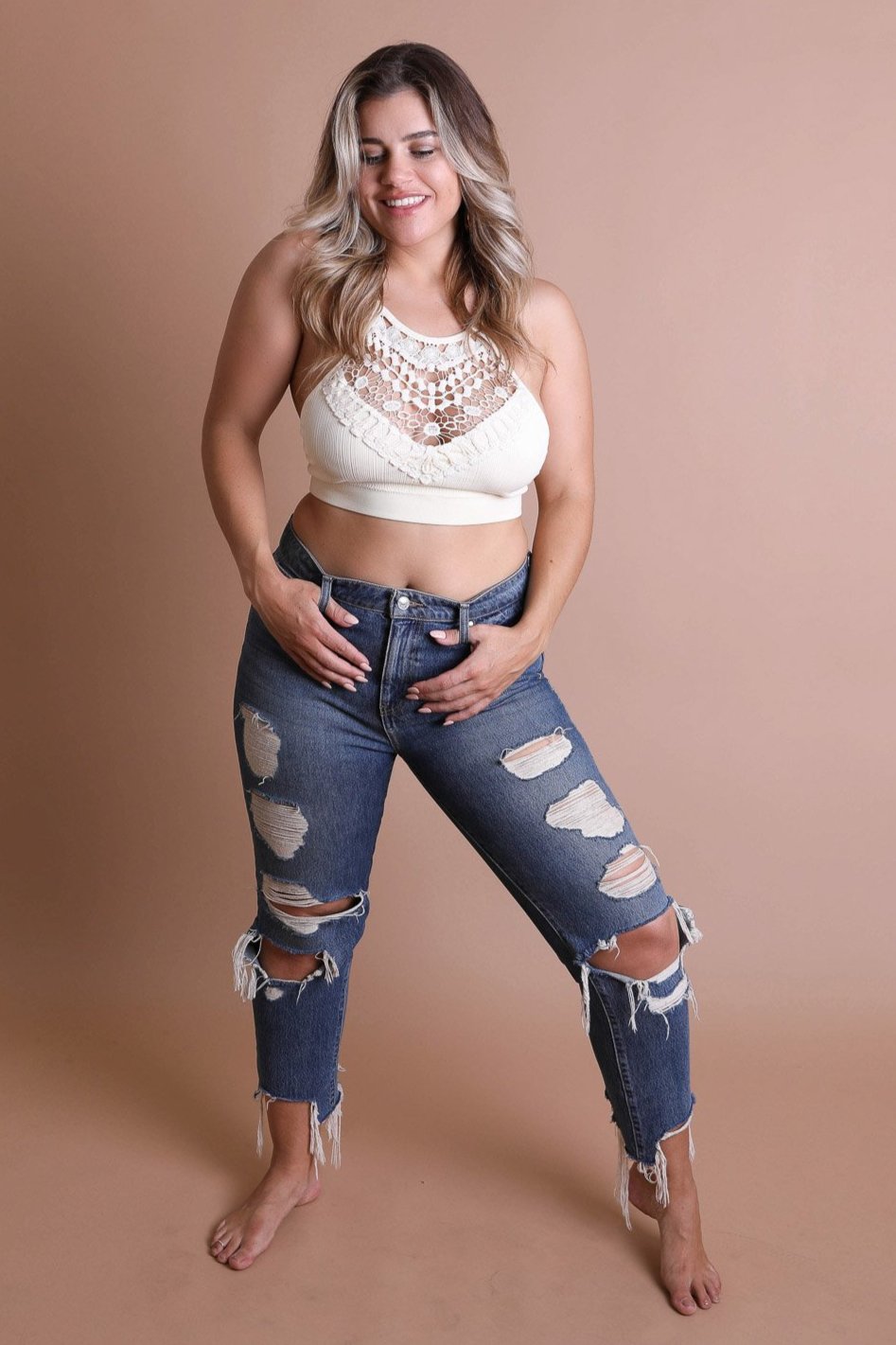 Stretchy ivory plus size lace bralette with cross-back straps.